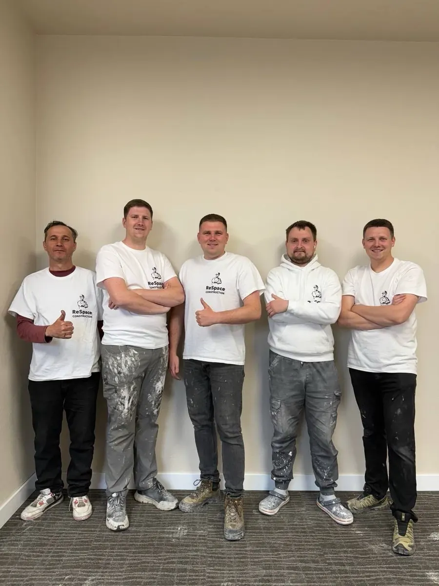 The ReSpace Construction crew in branded shirts after finishing a bathroom in Anchorage