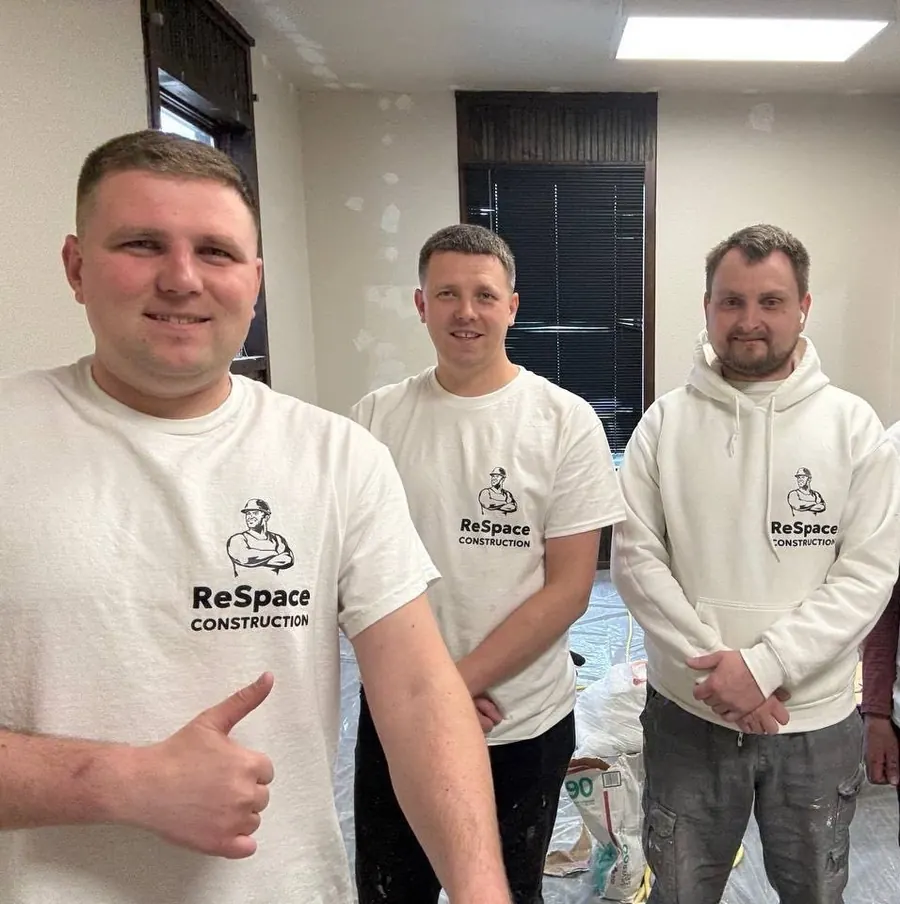 Three ReSpace Construction installers in branded hoodies on a job site