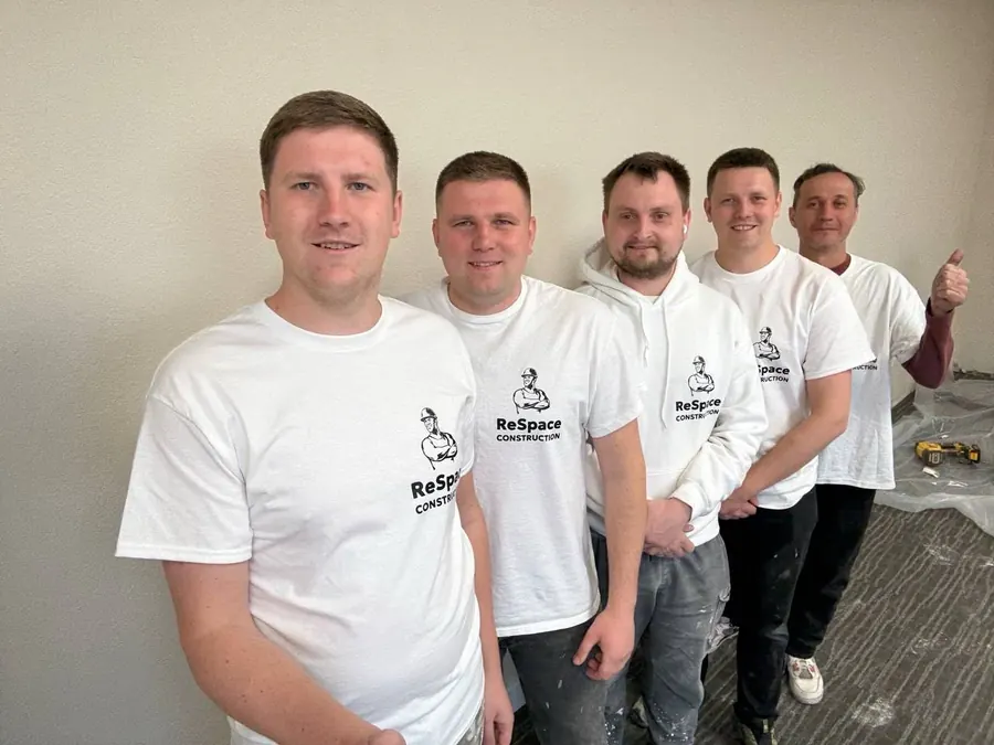The full ReSpace Construction install crew in a bathroom they just completed